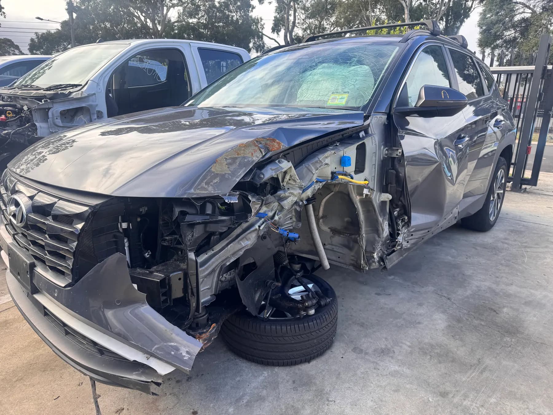 Damaged silver Hyundai being assessed in the PartsBase yard.