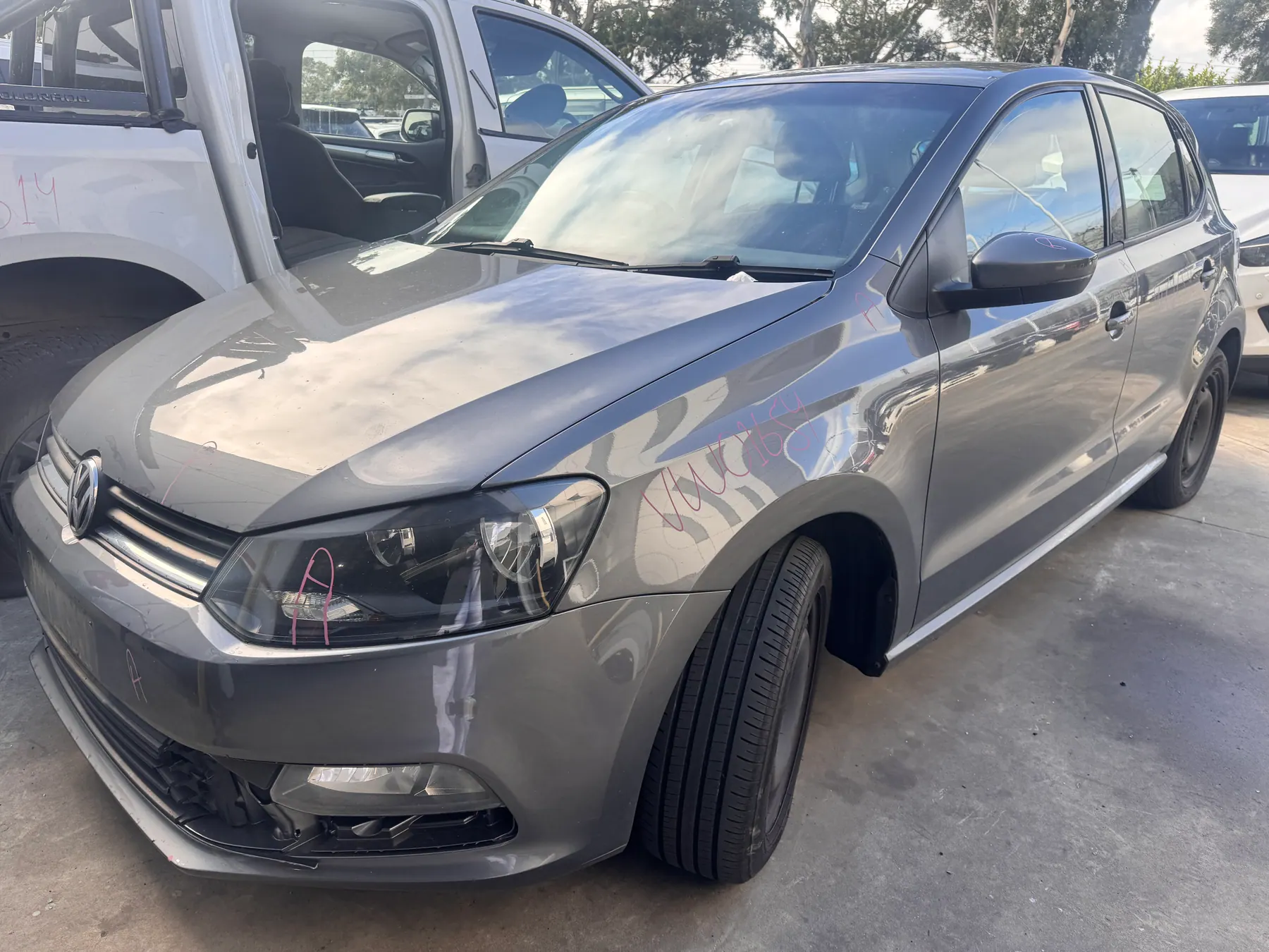 Silver Volkswagen in the yard ready for parts inspection.