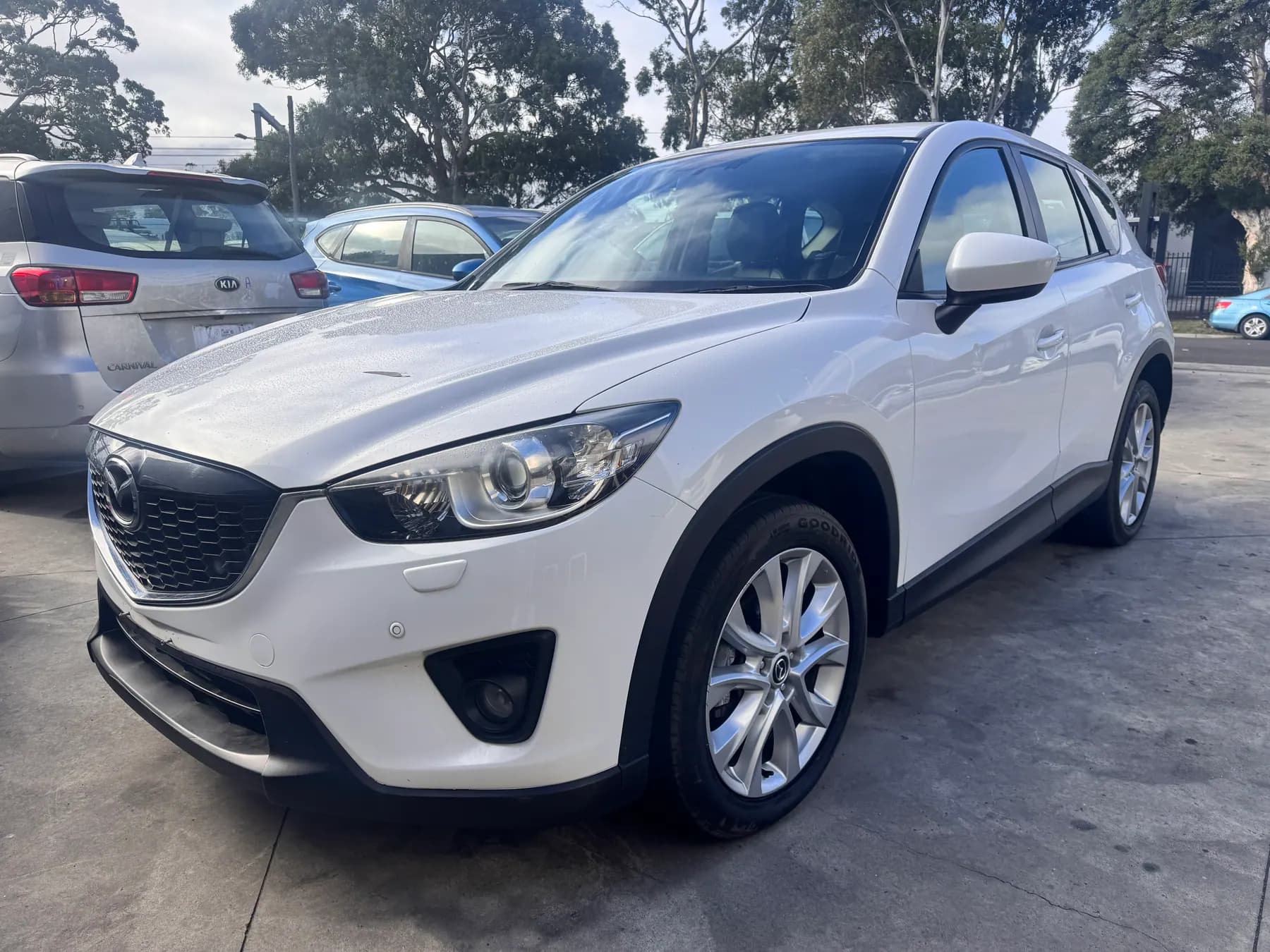 White Mazda SUV parked in the PartsBase yard.