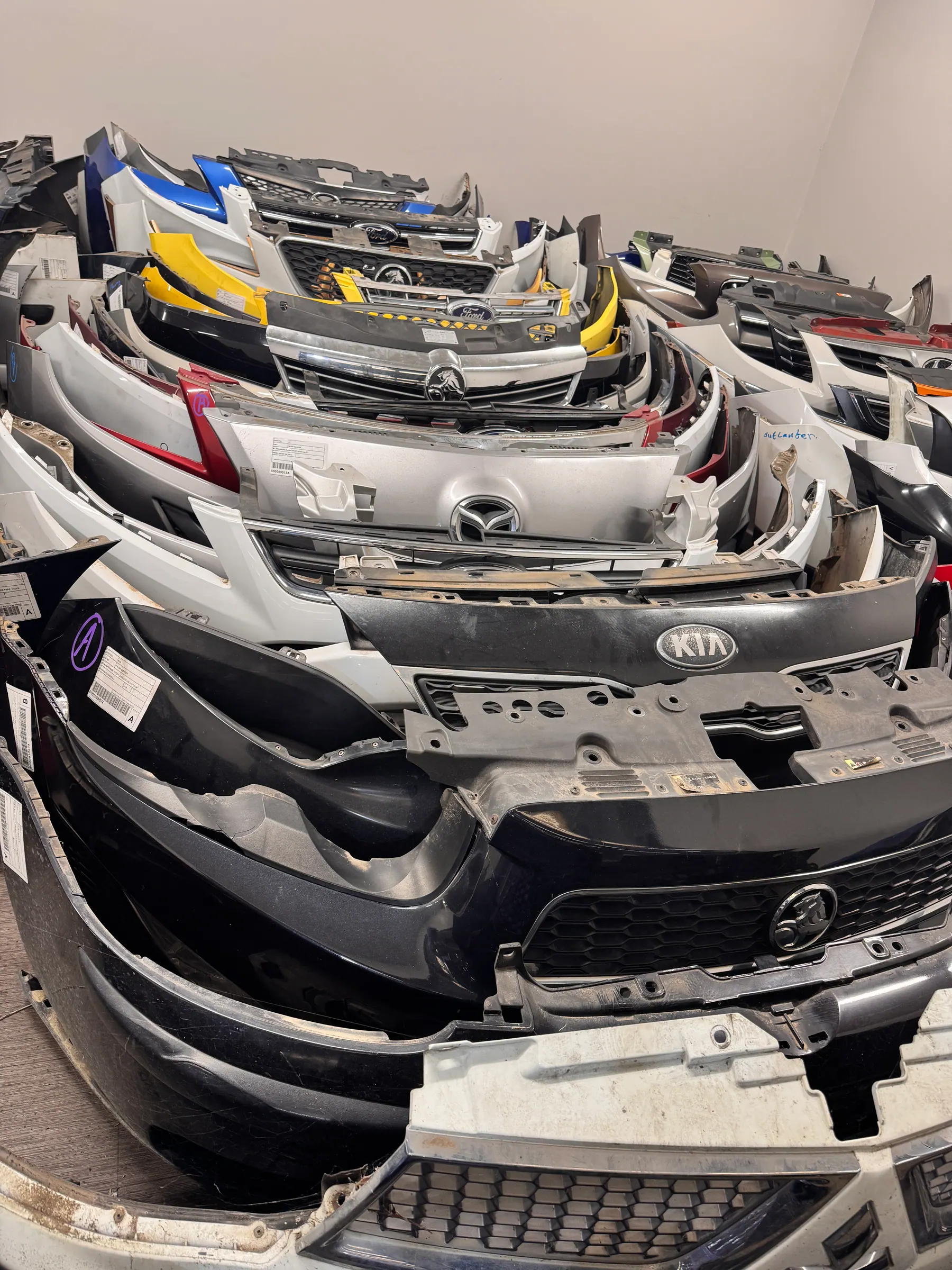 Bumper bars and front panels labelled and stored for dispatch.